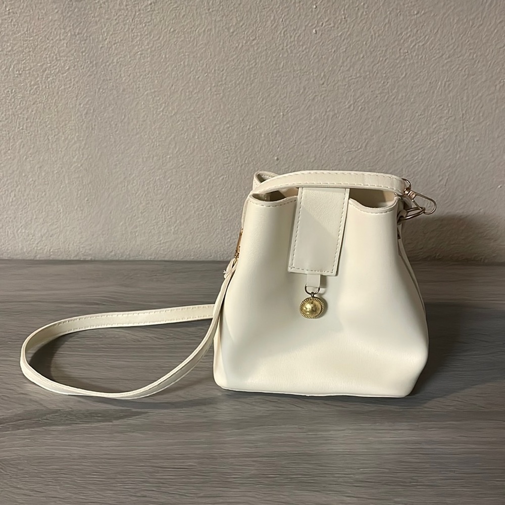 Vintage White cross body/ fashion/ adjustable straps/ bucket/ gold metal  accent